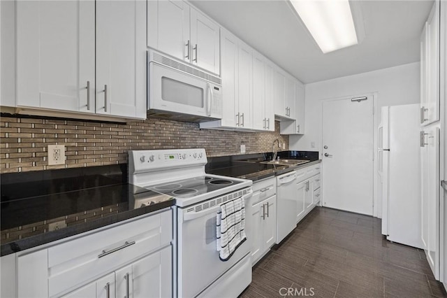 14506 Benefit St Unit 103, Sherman Oaks, CA 91403 - kitchen with white appliances, a sink, dark countertops, decorative backsplash, and white cabinets