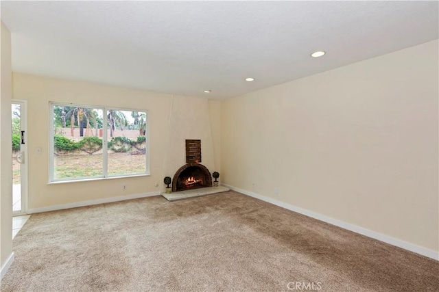 7605 Pasito Ave, Rancho Cucamonga, CA 91730 - unfurnished living room featuring carpet, baseboards, a lit fireplace, and recessed lighting