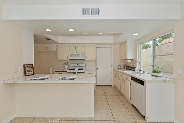 7605 Pasito Ave, Rancho Cucamonga, CA 91730 - kitchen with white appliances, a sink, a peninsula, light countertops, and light tile patterned floors
