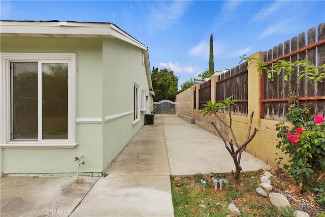 7605 Pasito Ave, Rancho Cucamonga, CA 91730 - view of side of property with a patio area, a fenced backyard, and stucco siding