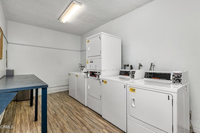 5354 Lindley Ave Unit 202, Encino, CA 91316 - community laundry room featuring stacked washer and clothes dryer, independent washer and dryer, light wood-style flooring, and a textured ceiling