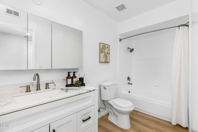 5354 Lindley Ave Unit 202, Encino, CA 91316 - bathroom with vanity, toilet, wood finished floors, and shower / bathtub combination with curtain