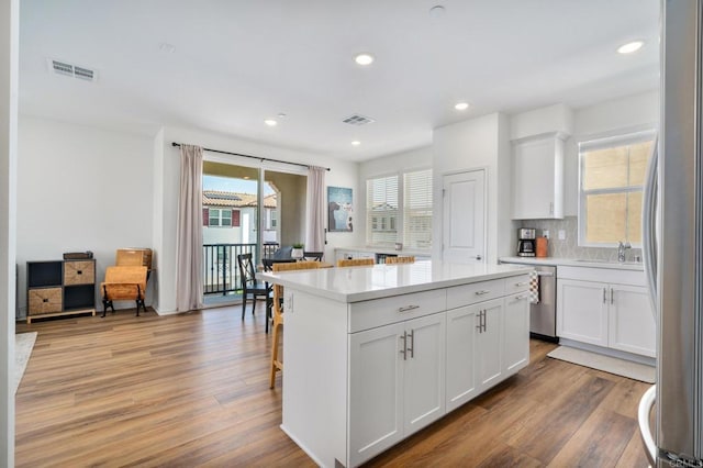 2328 Stardust Gln, Escondido, CA 92025 - kitchen with stainless steel dishwasher, recessed lighting, freestanding refrigerator, light wood-type flooring, and light countertops