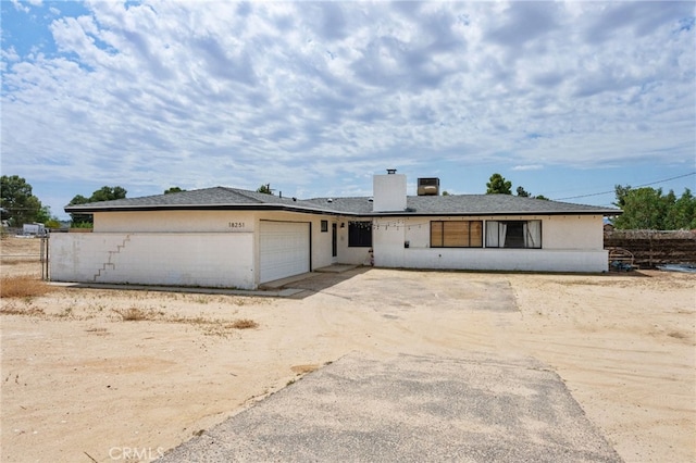 18251 Hiawatha Rd, Apple Valley, CA 92307 - ranch-style house featuring a garage, a chimney, and driveway