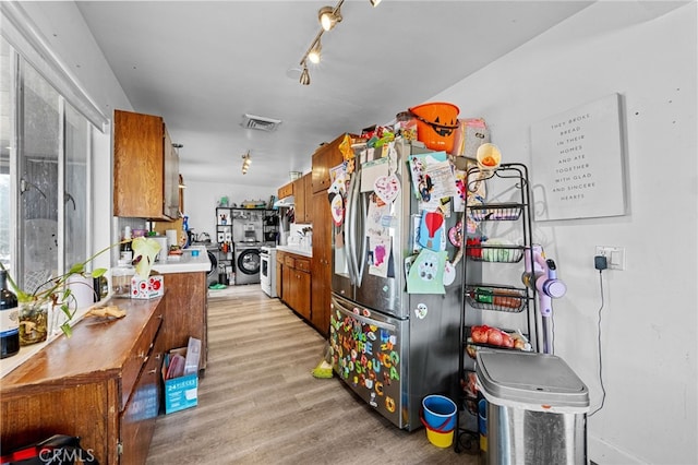 18251 Hiawatha Rd, Apple Valley, CA 92307 - kitchen with freestanding refrigerator, brown cabinets, light countertops, and light wood finished floors