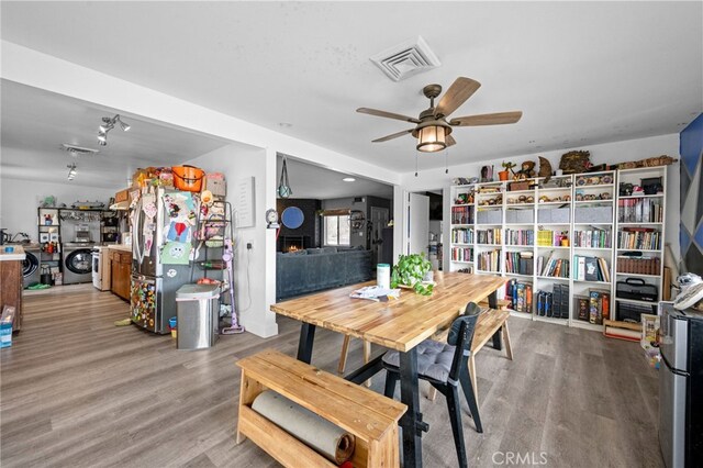 18251 Hiawatha Rd, Apple Valley, CA 92307 - dining room with wood finished floors, ceiling fan, and independent washer and dryer