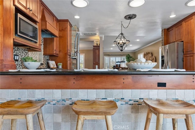 2645 S Patton Ave, San Pedro, CA 90731 - kitchen with stainless steel appliances, brown cabinetry, recessed lighting, dark countertops, and hanging light fixtures