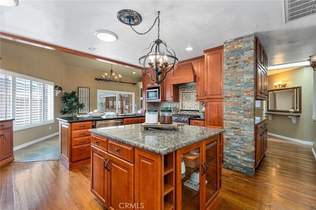 2645 S Patton Ave, San Pedro, CA 90731 - kitchen with a chandelier, baseboards, hardwood / wood-style floors, stainless steel appliances, and brown cabinetry