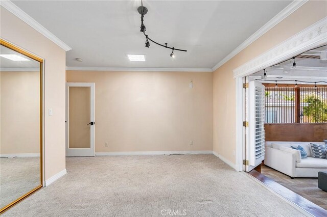 2645 S Patton Ave, San Pedro, CA 90731 - unfurnished living room with rail lighting, carpet, ornamental molding, and baseboards
