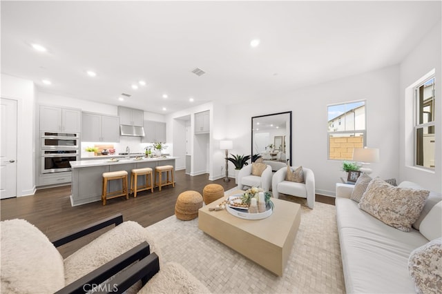 149 Great Park Blvd, Irvine, CA 92618 - living room featuring recessed lighting, dark wood-style flooring, and baseboards