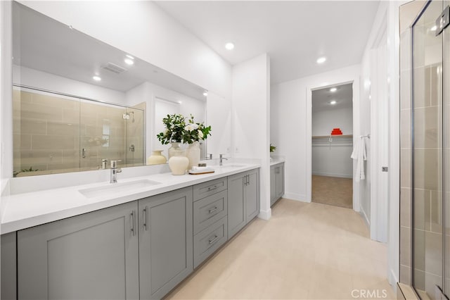 149 Great Park Blvd, Irvine, CA 92618 - bathroom featuring double vanity, a shower stall, a spacious closet, recessed lighting, and baseboards