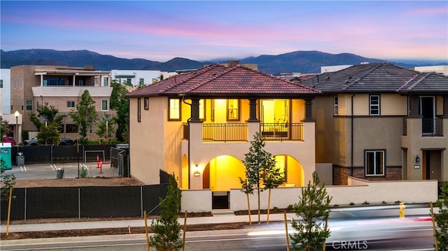 149 Great Park Blvd, Irvine, CA 92618 - rear view of property featuring a balcony, stucco siding, a mountain view, and a tiled roof