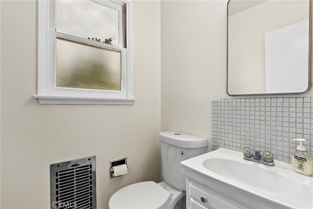 9241 Pali Ave, Tujunga, CA 91042 - half bathroom featuring toilet, vanity, and decorative backsplash