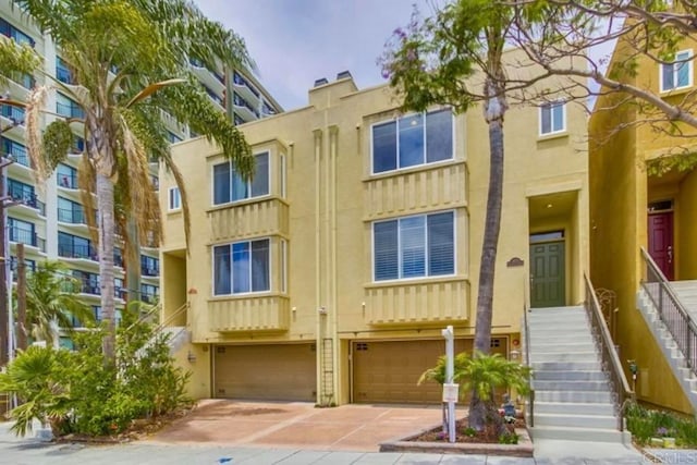 1820 University Ave, San Diego, CA 92103 - view of front of home featuring a garage, stairway, and stucco siding
