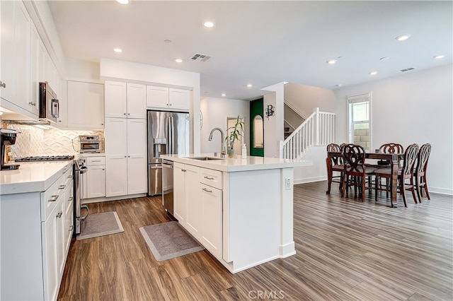 261 Siena, Lake Forest, CA 92630 - kitchen with a sink, stainless steel appliances, wood finished floors, light countertops, and backsplash