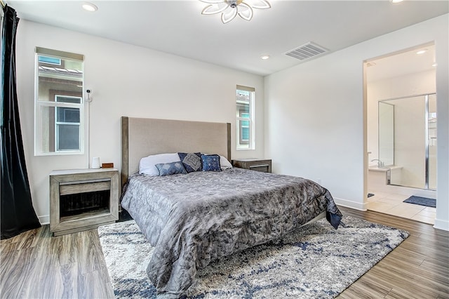 261 Siena, Lake Forest, CA 92630 - bedroom featuring recessed lighting, ensuite bath, wood finished floors, and baseboards