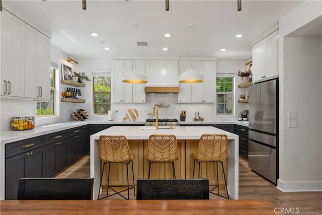 40 Lomada St, Rancho Mission Viejo, CA 92694 - kitchen featuring open shelves, freestanding refrigerator, backsplash, light wood finished floors, and recessed lighting