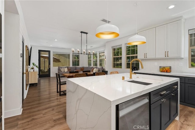 40 Lomada St, Rancho Mission Viejo, CA 92694 - kitchen with stainless steel dishwasher, light wood-style floors, pendant lighting, open floor plan, and recessed lighting