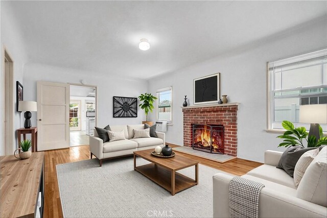 3224 Cerritos Ave, Signal Hill, CA 90755 - living area with wood finished floors and a brick fireplace