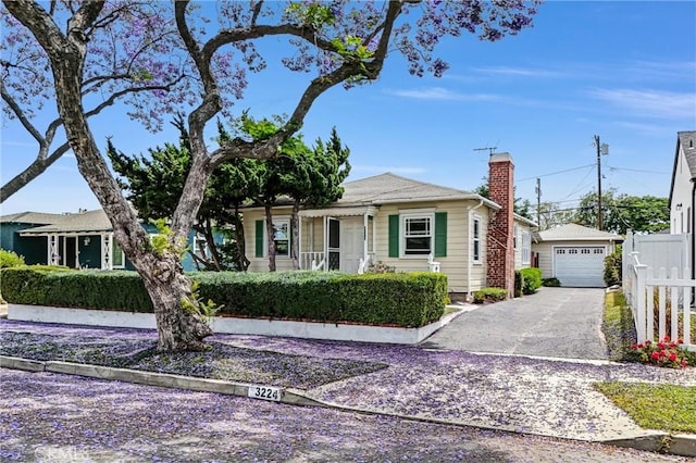 3224 Cerritos Ave, Signal Hill, CA 90755 - view of front of home with a chimney, asphalt driveway, and a detached garage