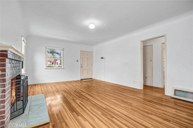 3224 Cerritos Ave, Signal Hill, CA 90755 - unfurnished living room featuring a fireplace and wood finished floors