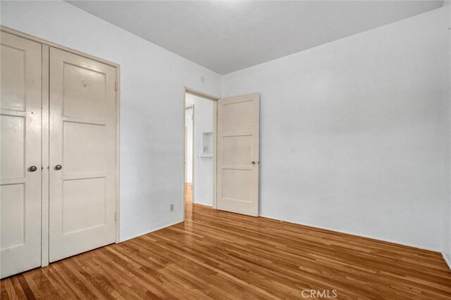 3224 Cerritos Ave, Signal Hill, CA 90755 - unfurnished bedroom with wood finished floors and a closet