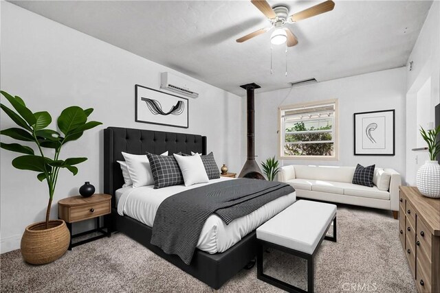 3224 Cerritos Ave, Signal Hill, CA 90755 - carpeted bedroom featuring a wall mounted air conditioner, a wood stove, and a ceiling fan