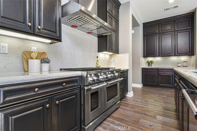23942 Schoenborn St, West Hills, CA 91304 - kitchen featuring wall chimney range hood, range with two ovens, dark wood-style floors, baseboards, and light stone counters