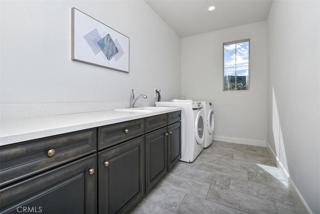 23942 Schoenborn St, West Hills, CA 91304 - laundry area featuring cabinet space, washer and dryer, baseboards, and light stone finish floors