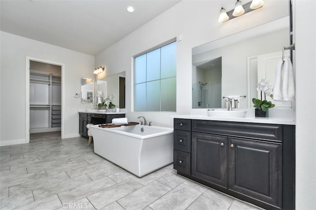 23942 Schoenborn St, West Hills, CA 91304 - bathroom with two vanities, a soaking tub, a shower, and a walk in closet