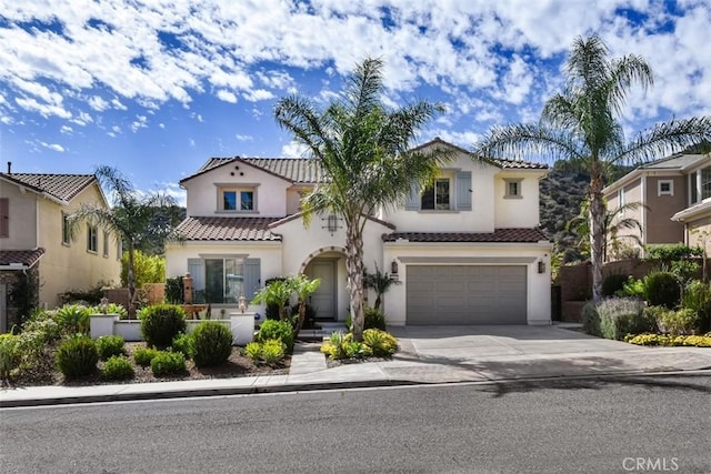 23942 Schoenborn St, West Hills, CA 91304 - mediterranean / spanish house with a tiled roof, driveway, stucco siding, and an attached garage