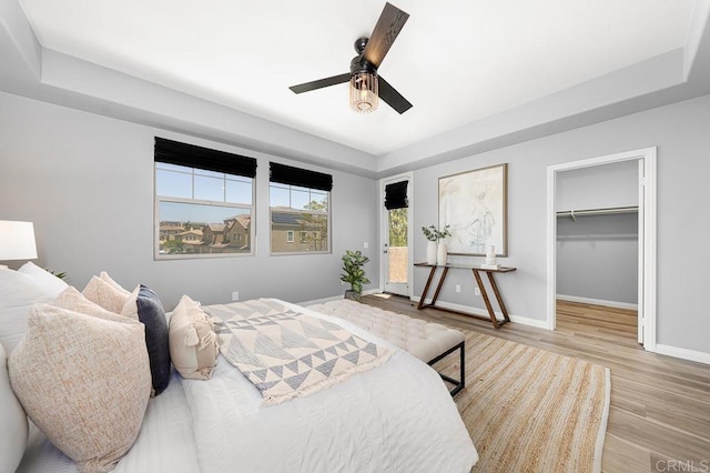 1686 Pember Ave, Chula Vista, CA 91913 - bedroom with a tray ceiling, wood finished floors, access to exterior, and ceiling fan