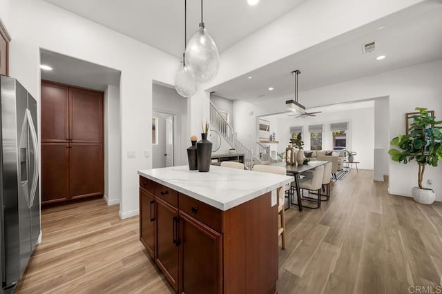 1686 Pember Ave, Chula Vista, CA 91913 - kitchen with stainless steel fridge, a ceiling fan, light wood-style floors, a kitchen island, and recessed lighting