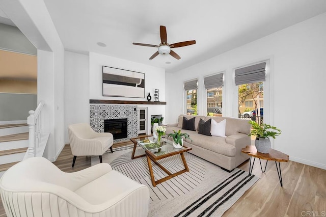 1686 Pember Ave, Chula Vista, CA 91913 - living room with wood finished floors, a ceiling fan, stairway, and a fireplace