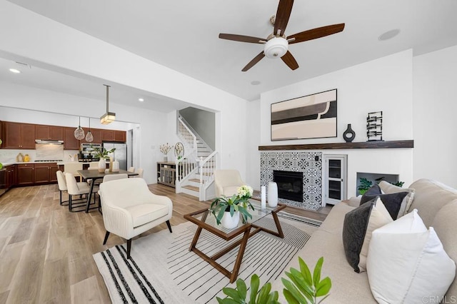 1686 Pember Ave, Chula Vista, CA 91913 - living room featuring stairs, light wood finished floors, a fireplace, a ceiling fan, and recessed lighting