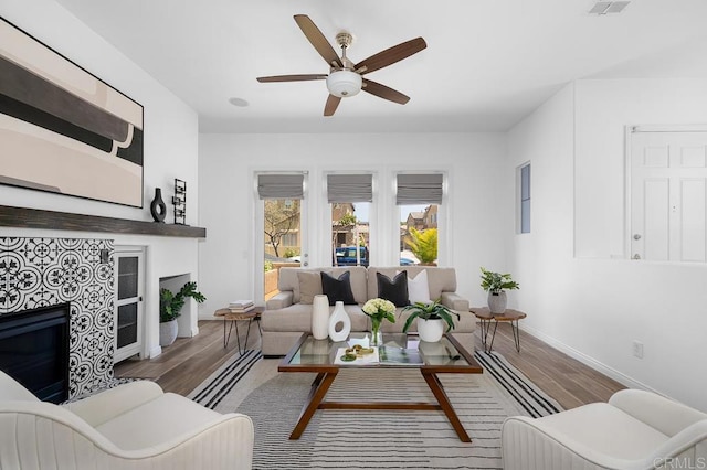 1686 Pember Ave, Chula Vista, CA 91913 - living room featuring a large fireplace, wood finished floors, and ceiling fan