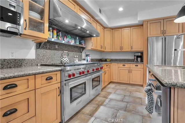 32811 Wesley St, Wildomar, CA 92595 - kitchen with ventilation hood, appliances with stainless steel finishes, a sink, light stone countertops, and glass insert cabinets