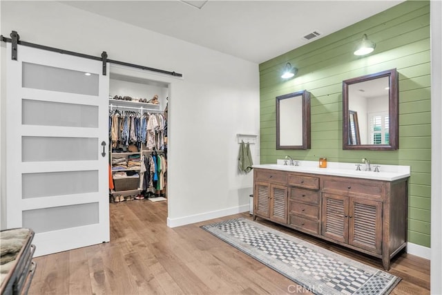 32811 Wesley St, Wildomar, CA 92595 - full bath with wood walls, double vanity, wood finished floors, and baseboards