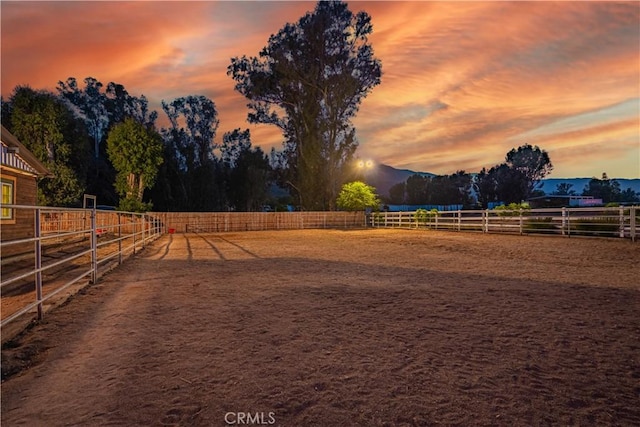 32811 Wesley St, Wildomar, CA 92595 - yard at dusk with an enclosed horse arena, a view of rural / pastoral area, and a mountain view