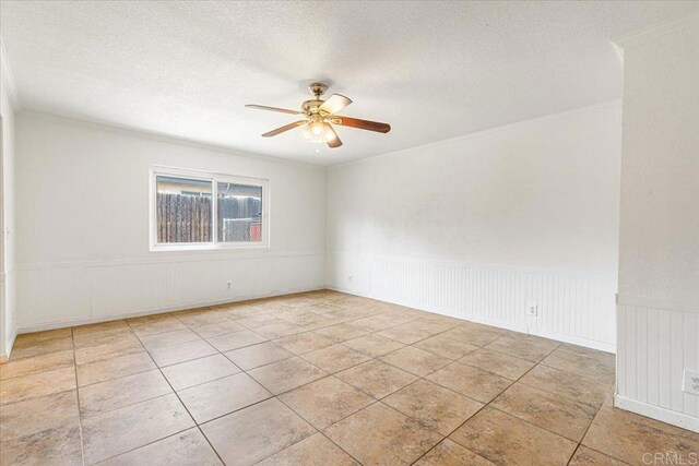 1105 Via Prado, Fallbrook, CA 92028 - empty room featuring a ceiling fan, crown molding, a textured ceiling, and a wainscoted wall