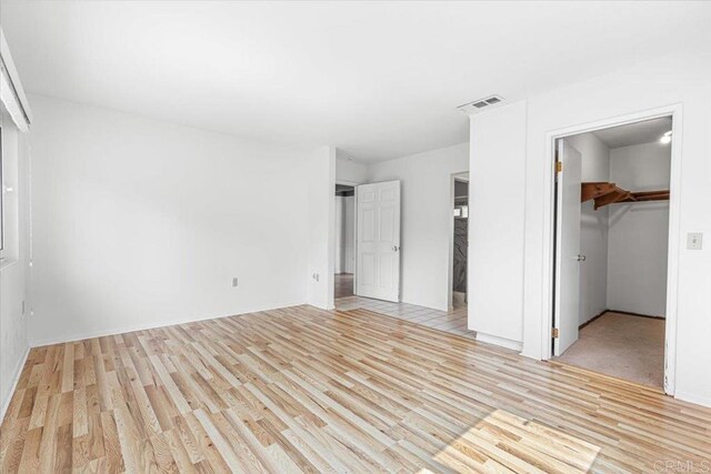 1105 Via Prado, Fallbrook, CA 92028 - unfurnished bedroom featuring light wood-style floors, a closet, a spacious closet, and baseboards