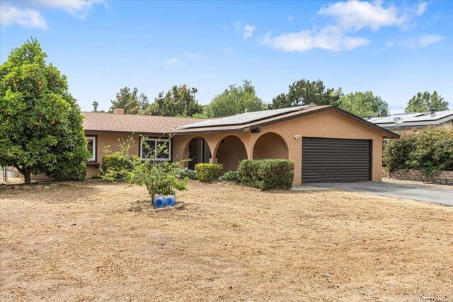 1105 Via Prado, Fallbrook, CA 92028 - single story home with roof mounted solar panels, driveway, a garage, and stucco siding
