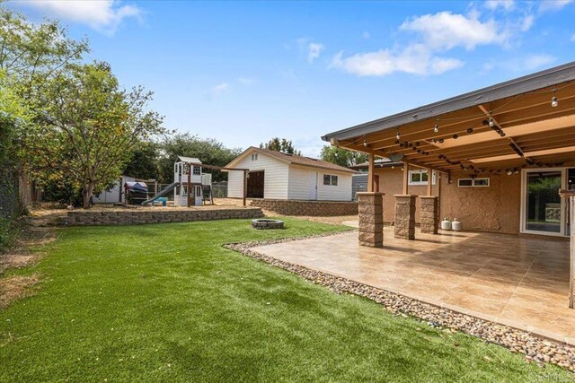 1105 Via Prado, Fallbrook, CA 92028 - view of yard featuring a playground, a patio, and an outbuilding