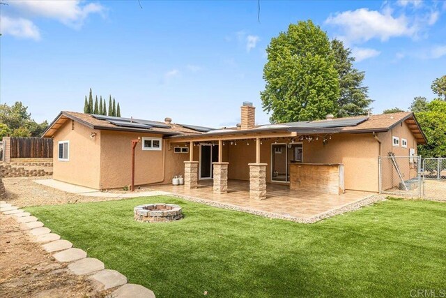 1105 Via Prado, Fallbrook, CA 92028 - rear view of house with a fire pit, solar panels, stucco siding, and a patio