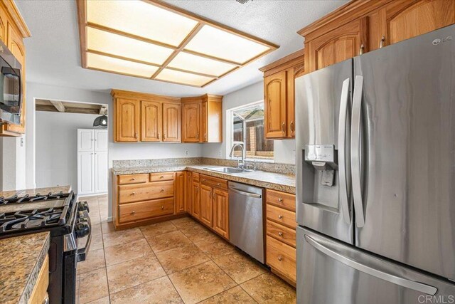 1105 Via Prado, Fallbrook, CA 92028 - kitchen with appliances with stainless steel finishes, a sink, light countertops, and brown cabinets