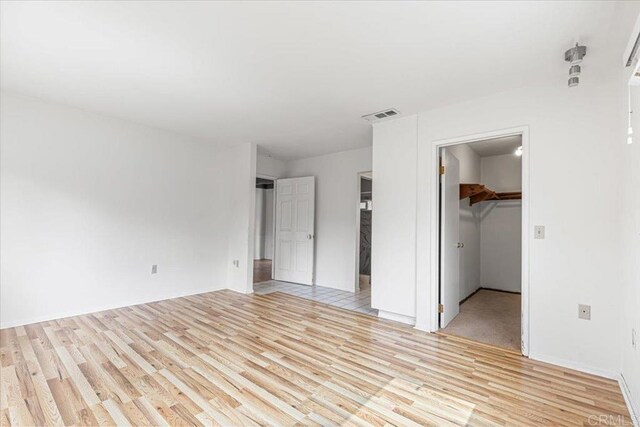 1105 Via Prado, Fallbrook, CA 92028 - unfurnished bedroom with light wood-type flooring, a walk in closet, and a closet