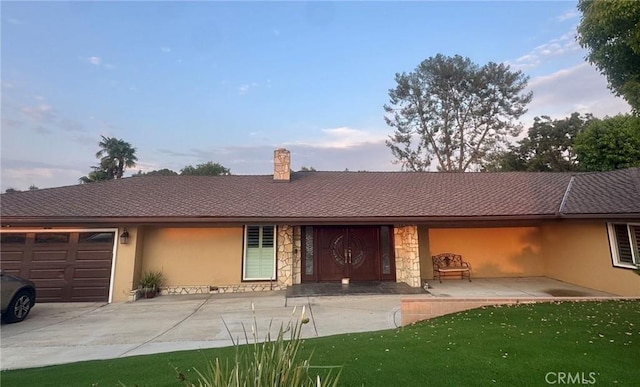 1020 S Montezuma Way, West Covina, CA 91791 - ranch-style house with stucco siding, a garage, stone siding, driveway, and a chimney