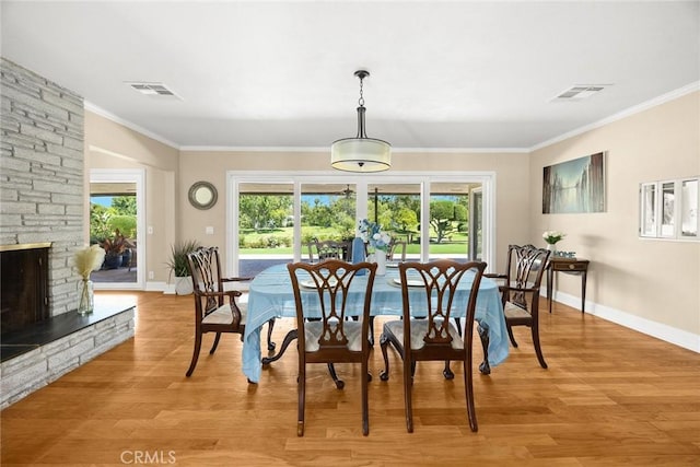 1020 S Montezuma Way, West Covina, CA 91791 - dining room with light wood-style flooring, ornamental molding, and a stone fireplace