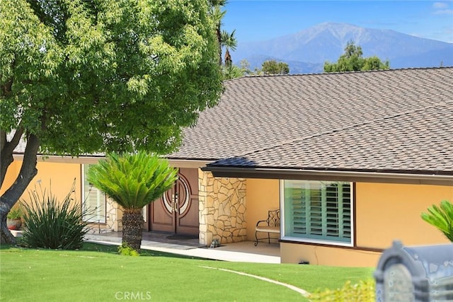 1020 S Montezuma Way, West Covina, CA 91791 - back of property with stone siding, a mountain view, stucco siding, a lawn, and a patio area