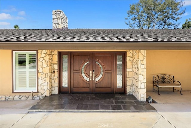 1020 S Montezuma Way, West Covina, CA 91791 - doorway to property featuring stone siding, a chimney, and roof with shingles